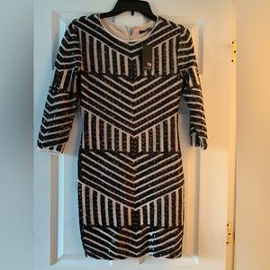 Super cute mini dress! Nude color with black beading. Adorable for a night out!